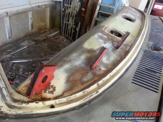 1967 Ford F-100 dashboard, rusty and partially disassembled, with red magnetic clamps attached