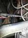 1987 Ford Bronco - Close-up view of an engine bay, showing various hoses, wires, and a component with a question superimposed on the image.