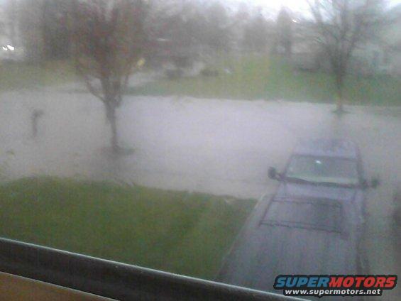 Dark SUV in flooded street