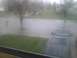 2003 Ford Crown Victoria - A dark SUV is partially submerged in a flooded street during inclement weather.