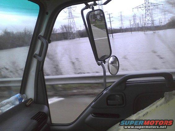 Truck interior view of a flooded road with power lines