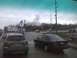 2003 Ford Crown Victoria - View of a traffic intersection during a rainstorm, with several vehicles visible.