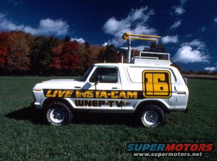 White van with 'LIVE INSTA-CAM WNEP-TV' and a large yellow '16' on the side, parked on grass with trees in background