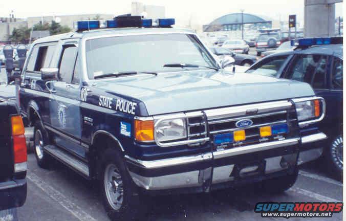 Light blue Ford Bronco police SUV with "STATE POLICE" text, light bar, and push bumper