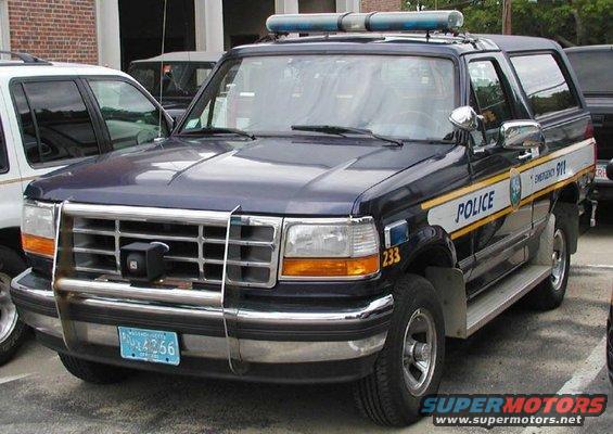 1994 Ford Bronco police SUV with light bar and 'POLICE' markings