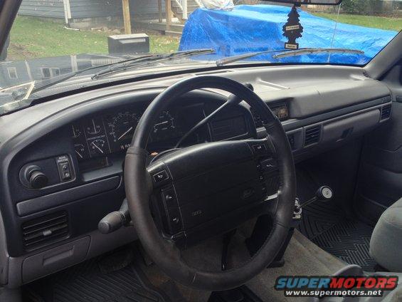 Dashboard and steering wheel of a truck, possibly a Ford Bronco. The dashboard has gauges and vents