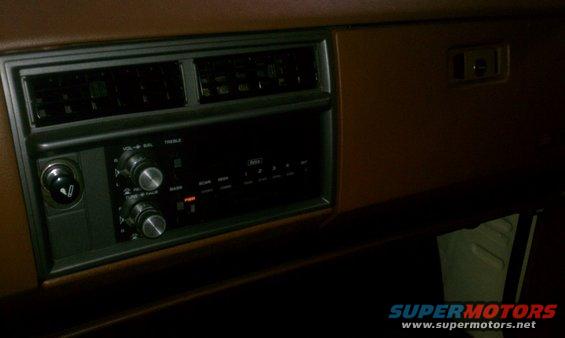Dashboard with radio, air vents, and cigarette lighter. The radio has knobs for volume, balance, and tuning