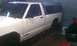 1991 Chevrolet S10 - Side view of a 1991 Chevrolet S10 pickup truck with a camper shell, showing rust damage.