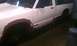 1991 Chevrolet S10 - A white pickup truck is shown from the side, with primer applied to the wheel wells and the front wheel missing.