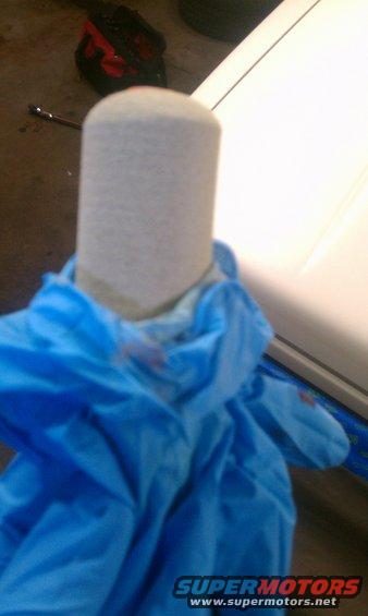 Oil filter held by blue gloves