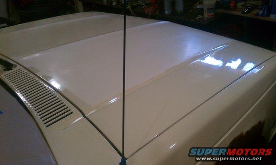 truck hood and fender, antenna in middle, grille on left
