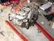 1992 Ford Taurus - Engine assembly being worked on, with various tools and supplies scattered around the garage floor.