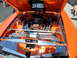 1973 Ford Ranchero - Custom engine bay with "514 mach1" text. The vehicle is orange and features chrome detailing.