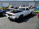 1973 Ford Ranchero - A white 1973 Ford Ranchero is displayed with its hood open at a car show.