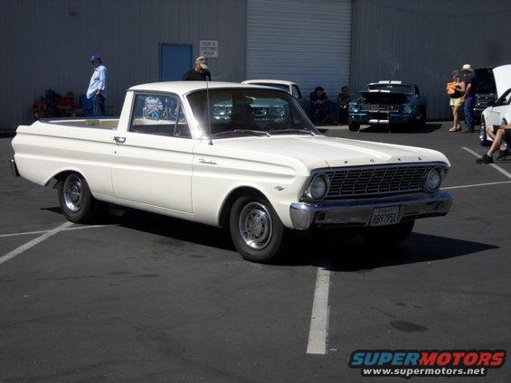 white pickup truck with a bed, parked in a lot