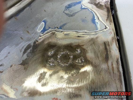 Metal panel with circular welding pattern and blue primer patches