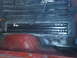 1978 Ford Bronco - Close-up of the interior floor of a vehicle, showing metal reinforcement work and a red wheel well.