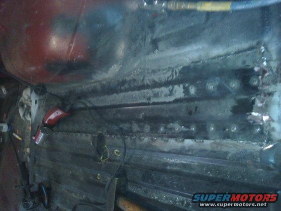 Interior of a vehicle with exposed metal and repair tools