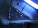 1978 Ford Bronco - This image shows a close-up view of welded metal, rivets, and a hole in what appears to be a vehicle's frame.