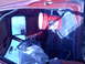 1978 Ford Bronco - Interior view of a red truck cab with a bucket hanging and items covered in plastic.