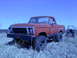1978 Ford Bronco - This 1978 Ford Bronco is shown in a three-quarter front view, parked in a field with a tractor behind it.