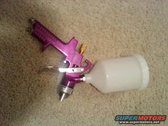 Purple spray gun with a white plastic cup attached to the bottom