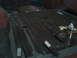 1978 Ford Bronco - Tools and a spray can are on the ribbed floor of a vehicle's interior.