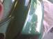 2003 Ford Crown Victoria - A reflection in a green car part shows a motorcycle and a house.