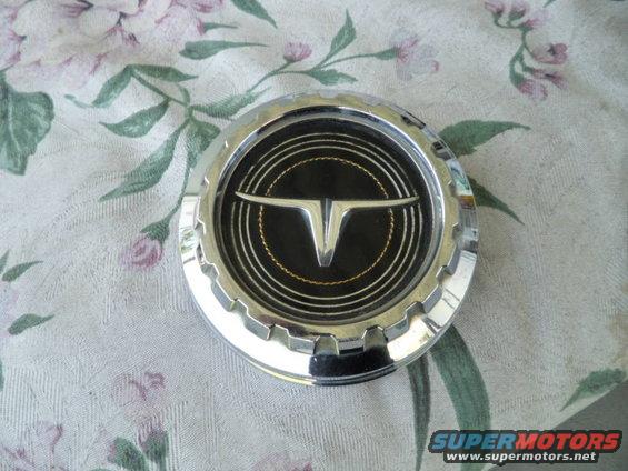 Chrome hubcap with black center and silver V emblem