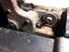 1995 Ford Bronco - A close-up view of a rusted metal bracket, showing mechanical components and an orange arrow.