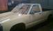 1991 Chevrolet S10 - A pickup truck is being prepared for a paint job, with masking tape covering the windows.