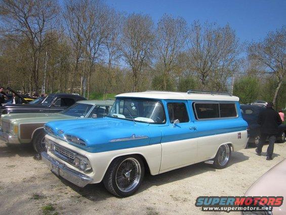 1959 Chevrolet Suburban two-tone blue and white with chrome wheels parked outdoors