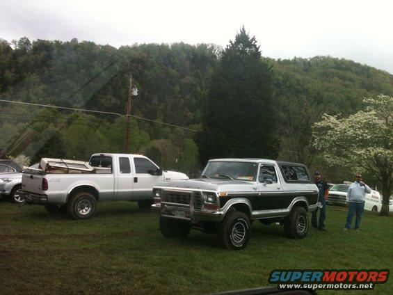 Two-tone silver and black Ford Bronco parked on grass, front 3/4 view