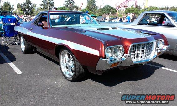 Maroon and silver 1972 Ford Ranchero GT with chrome wheels, parked on asphalt