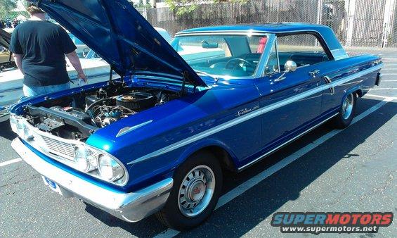 Blue 1962 Ford Fairlane 500 coupe, hood open showing engine