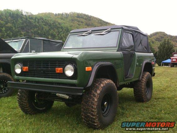 Green SUV with soft top and large tires