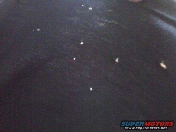 Black surface with white specks and Supermotors watermark