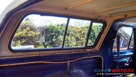 1979 Ford Bronco interior showing slider windows and blue upholstery