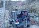 1992 Ford Bronco - Rear view of a Jeep Wrangler parked on a rocky, wooded trail. An orange flag is attached to the antenna.