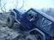 1992 Ford Bronco - A black Jeep Wrangler navigates a challenging rocky incline, with a person visible in the driver's seat.