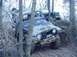 1992 Ford Bronco - Two Jeep Wranglers navigating a muddy, wooded off-road course.