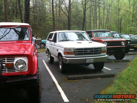 White 1992 Ford Bronco parked in a line with other Broncos