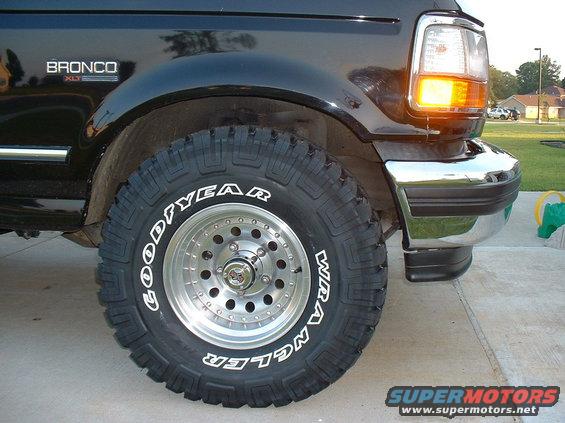 Black 1995 Ford Bronco XLT front fender and tire, chrome bumper, and amber turn signal