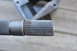 1974 Ford Bronco - A close-up of a driveshaft spline with a metal collar is shown against a blurred background.