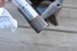 1974 Ford Bronco - A close-up view of a splined metal shaft, possibly a component from a vehicle, with a paper towel in the background.