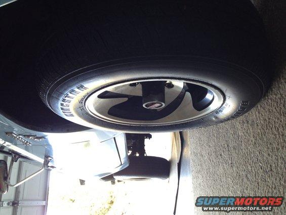 spare tire on a silver alloy wheel with a black center cap
