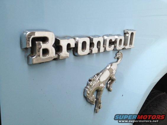 Bronco II emblem and horse mascot on light blue vehicle body panel