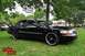 2000 Mercury Grand Marquis - Black 2000 Mercury Grand Marquis with custom wheels parked on grass at an outdoor gathering.