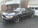 2000 Mercury Grand Marquis - A black 2000 Mercury Grand Marquis is parked in front of a brick house and garage, custom wheels.