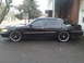 2000 Mercury Grand Marquis - Side view of a black 2000 Mercury Grand Marquis modified with custom rims.